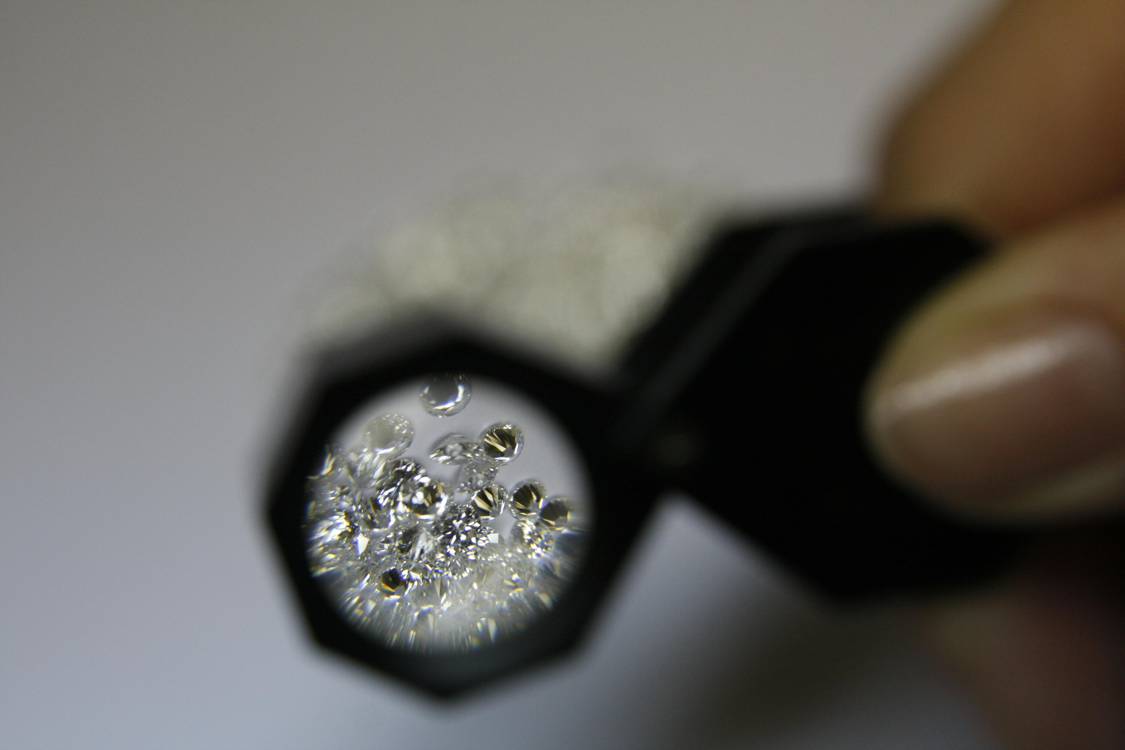 diamonds being examined with a loupe